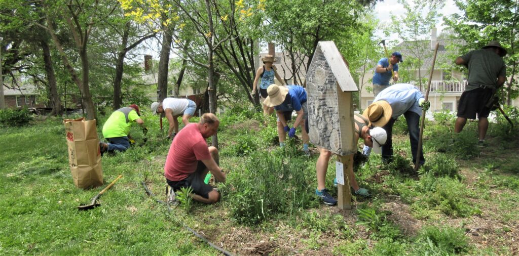 Neighbors providing mutual aid by working on a community garden. 