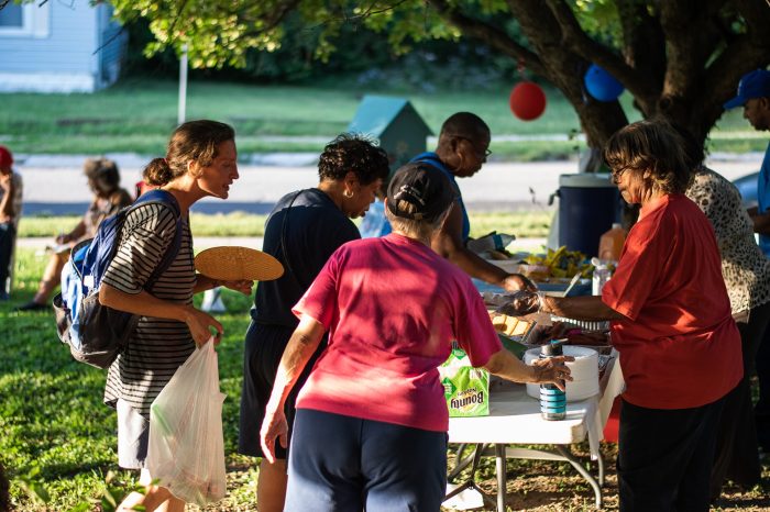 A photo showing people celebrating after planning a block party.